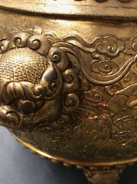 A Chinese gilt bronze tripod censer with buddhist lions, Qianlong mark, 19/20th C.