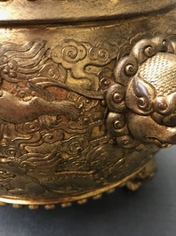 A Chinese gilt bronze tripod censer with buddhist lions, Qianlong mark, 19/20th C.