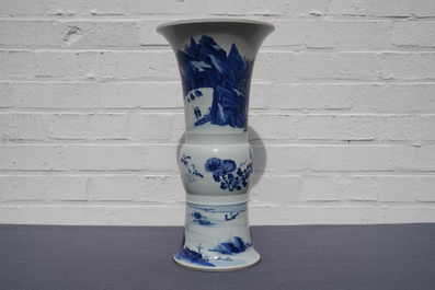 Een Chinese blauw-witte gu vaas met landschapsdecor, Kangxi merk en periode