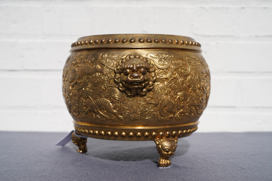 A Chinese gilt bronze tripod censer with buddhist lions, Qianlong mark, 19/20th C.