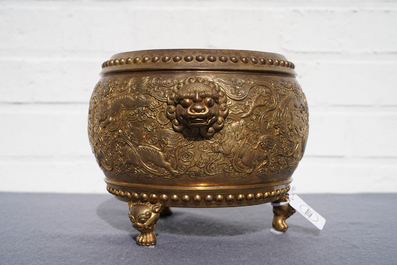 A Chinese gilt bronze tripod censer with buddhist lions, Qianlong mark, 19/20th C.