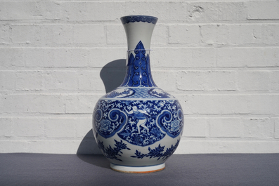 A Chinese blue and white bottle vase with dancers on a floral ground, 19th C.