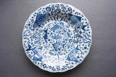 Two Chinese blue and white gadrooned 'crabs and carps' dishes and a pair of plates, Kangxi