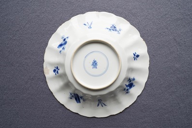 Two Chinese blue and white gadrooned 'crabs and carps' dishes and a pair of plates, Kangxi