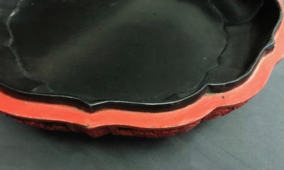 A Chinese cinnabar lacquer box and cover with figures in a landscape, 19th C.
