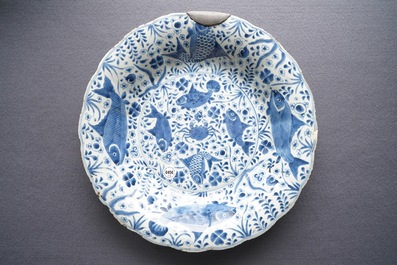 Two Chinese blue and white gadrooned 'crabs and carps' dishes and a pair of plates, Kangxi