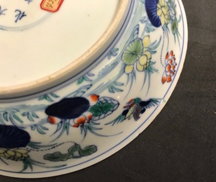 A pair of Chinese doucai 'ducks and lotus pond' plates, Chenghua mark, 18th C.