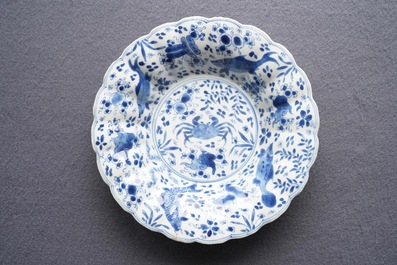 Two Chinese blue and white gadrooned 'crabs and carps' dishes and a pair of plates, Kangxi
