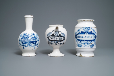 A large Dutch Delft blue and white albarello, a wet drug jar and a Brussels faience bottle, 18th C.
