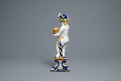 A polychrome Dutch Delft model of a boy, allegory of spring, 18th C.