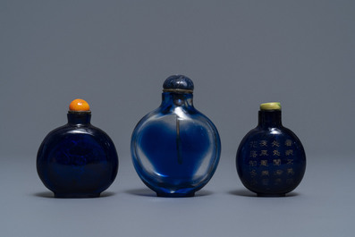 Three Chinese transparent blue glass snuff bottles, one inscribed, 18/19th C.