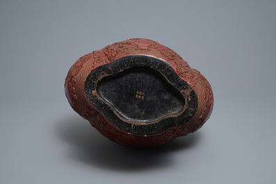A Chinese carved cinnabar lacquer vase, Qianlong mark, 19/20th C.