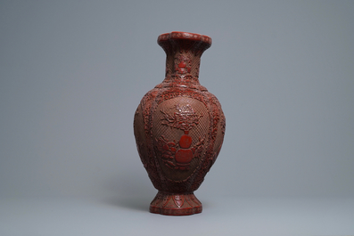 A Chinese carved cinnabar lacquer vase, Qianlong mark, 19/20th C.