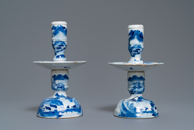 Een paar Chinese blauw-witte kandelaars en drie famille rose figuren van jongens, 19e eeuw