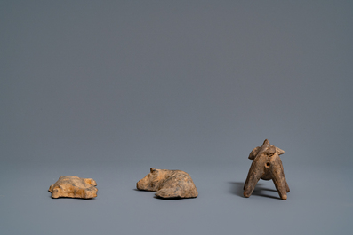 A Chinese earthenware model of a stable and five animals, Han