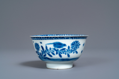 A Chinese blue and white 'mother with child' cup and saucer, Kangxi
