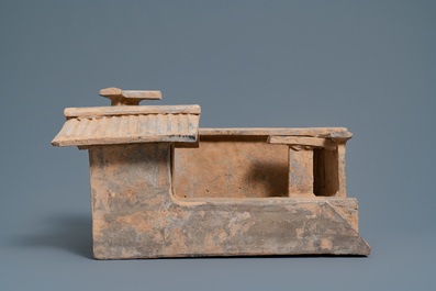 A Chinese earthenware model of a stable and five animals, Han