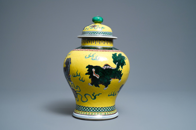 A Chinese yellow-ground famille verte vase and cover with Buddhist lions, 19th C.