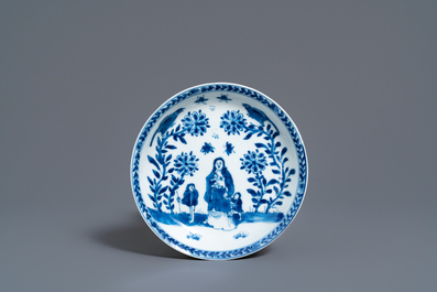 A Chinese blue and white 'mother with child' cup and saucer, Kangxi