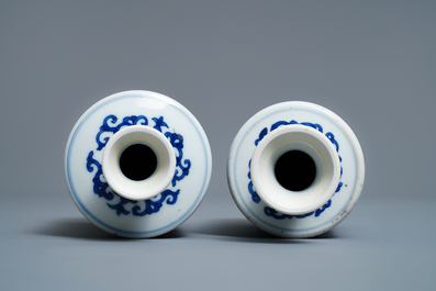 A pair of Chinese blue and white 'Buddhist emblems' rouleau vases, Kangxi