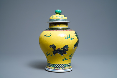 A Chinese yellow-ground famille verte vase and cover with Buddhist lions, 19th C.