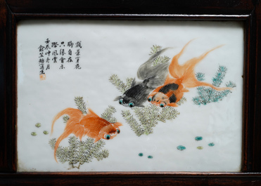 A Chinese wooden closet with 23 qianjiang cai plaques, 19/20th C.