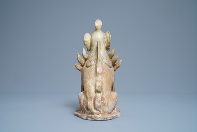 A Chinese straw-glazed stoneware 'earth spirit', Sui (581-617)