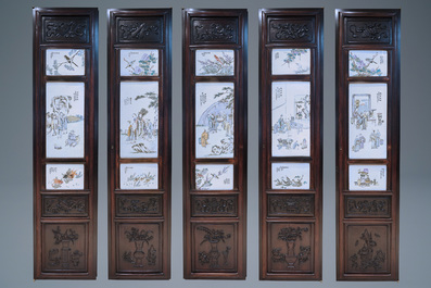 A Chinese wooden closet with 23 qianjiang cai plaques, 19/20th C.