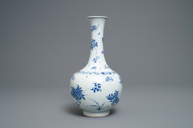 A Chinese blue and white bottle vase with floral design, Transitional period