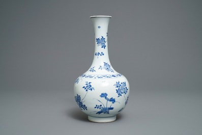 A Chinese blue and white bottle vase with floral design, Transitional period