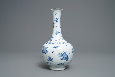 A Chinese blue and white bottle vase with floral design, Transitional period