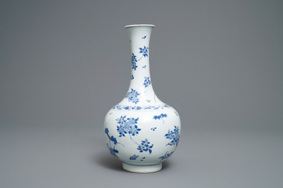 A Chinese blue and white bottle vase with floral design, Transitional period