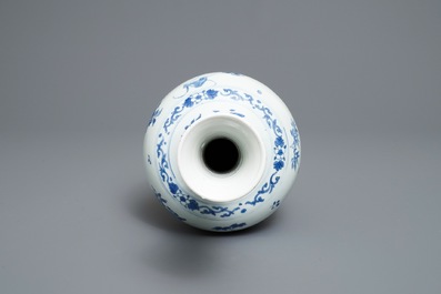 A Chinese blue and white bottle vase with floral design, Transitional period