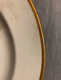 A Chinese grisaille 'Return from the hunt' dish with a coat of arms on the back, Qianlong