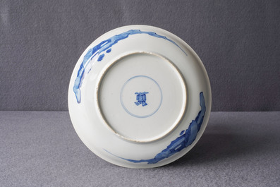 A Chinese blue and white semi-eggshell plate with a lady carrying a child, Kangxi