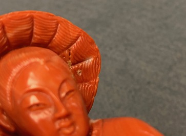 A Chinese carved red coral group of a boy with a parrot, 19/20th C.