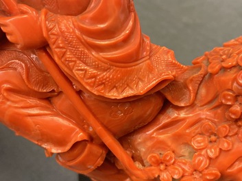 A Chinese carved red coral group of a boy with a parrot, 19/20th C.