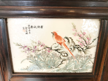 A Chinese wooden closet with 23 qianjiang cai plaques, 19/20th C.