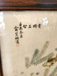 A Chinese wooden closet with 23 qianjiang cai plaques, 19/20th C.