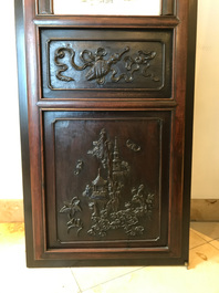 A Chinese wooden closet with 23 qianjiang cai plaques, 19/20th C.