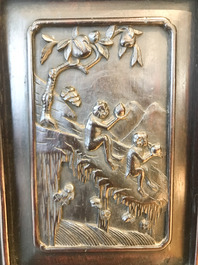 A Chinese wooden closet with 23 qianjiang cai plaques, 19/20th C.
