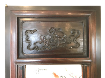 A Chinese wooden closet with 23 qianjiang cai plaques, 19/20th C.