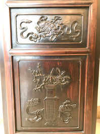 A Chinese wooden closet with 23 qianjiang cai plaques, 19/20th C.