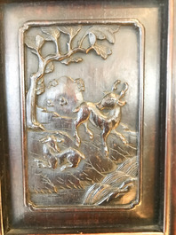 A Chinese wooden closet with 23 qianjiang cai plaques, 19/20th C.
