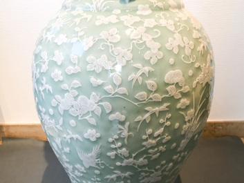 A large Chinese slip-decorated celadon-ground vase, 19th C.