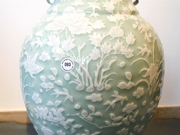 A large Chinese slip-decorated celadon-ground vase, 19th C.