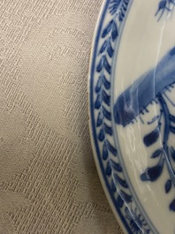 A Chinese blue and white 'mother with child' cup and saucer, Kangxi