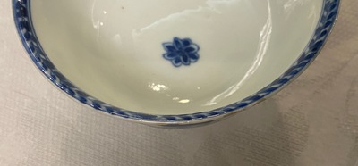 A Chinese blue and white 'mother with child' cup and saucer, Kangxi