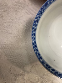 A Chinese blue and white 'mother with child' cup and saucer, Kangxi