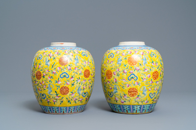 A pair of Chinese yellow-ground famille rose 'bats and shou' jars, Qianlong mark, 19th C.